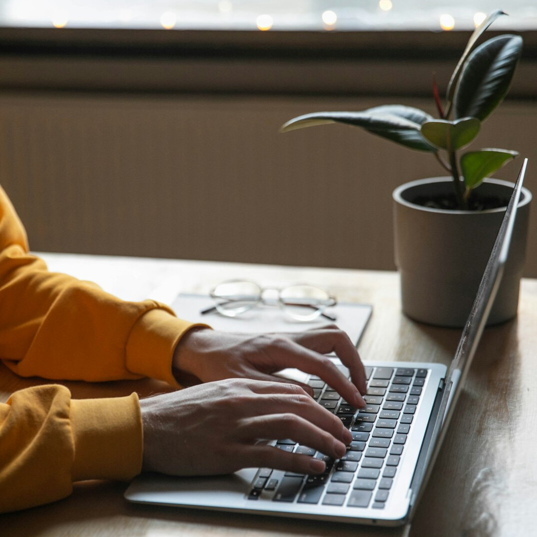 writer typing on laptop at desk